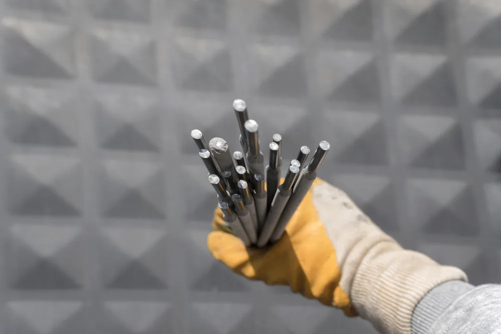 welding rods held in hand