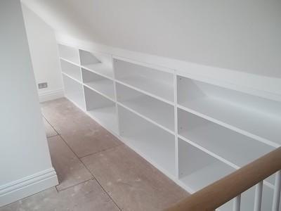 MDF shelves are made of wood on the right side of the wall of the kitchen.