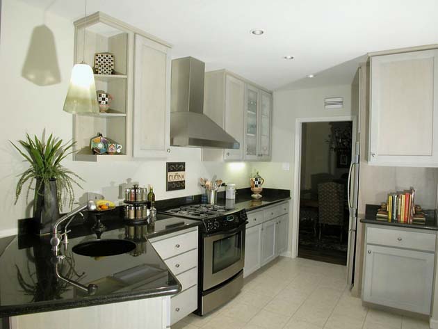 Black and white kitchen look with a door in the center and stainless steel hood over the stove.