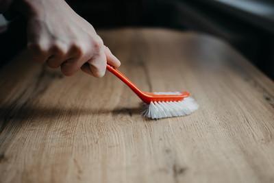 A soft cleaning brush used for cleaning a dirty and greasy kitchen exhaust hood.