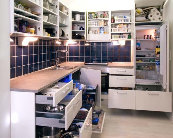 A modernistic design kitchen with multiple sliding shelves and properly organized cabinets and countertops.