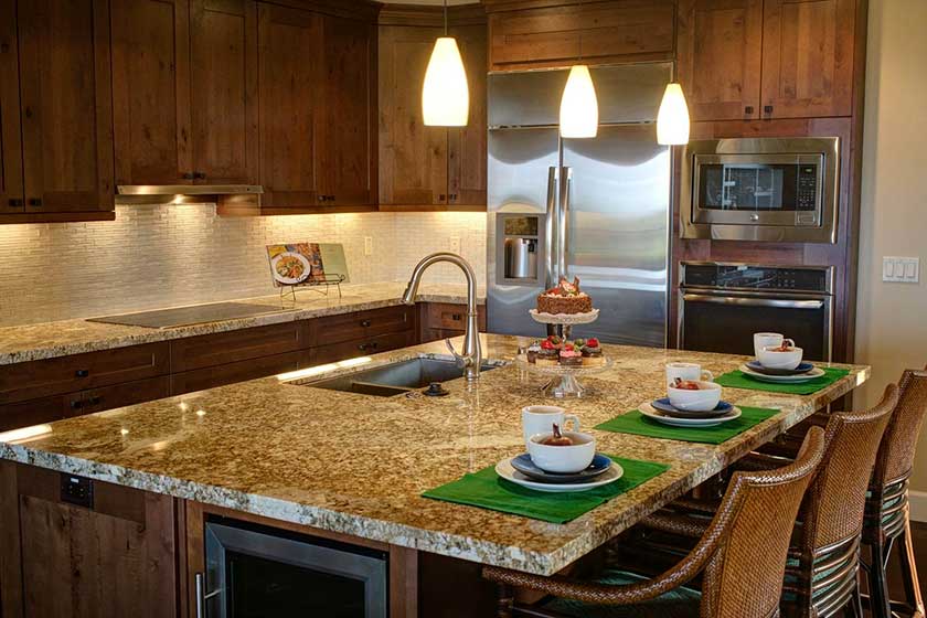 Marble kitchen countertop with cups and bowls on greem coster 