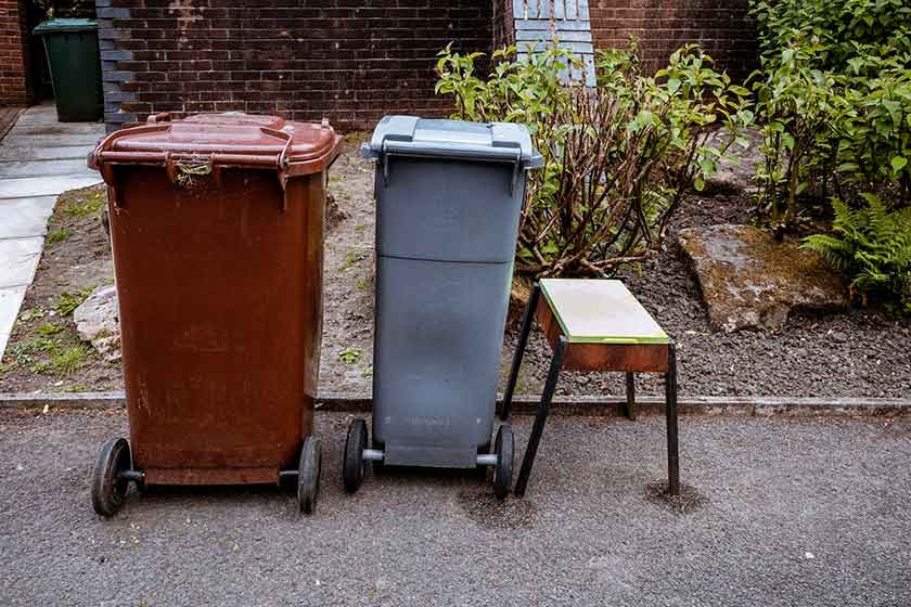 Two wheel dust bins on the road