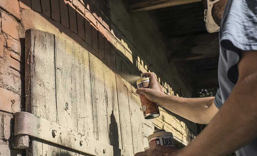 painting the cabinets with a yellow spray can