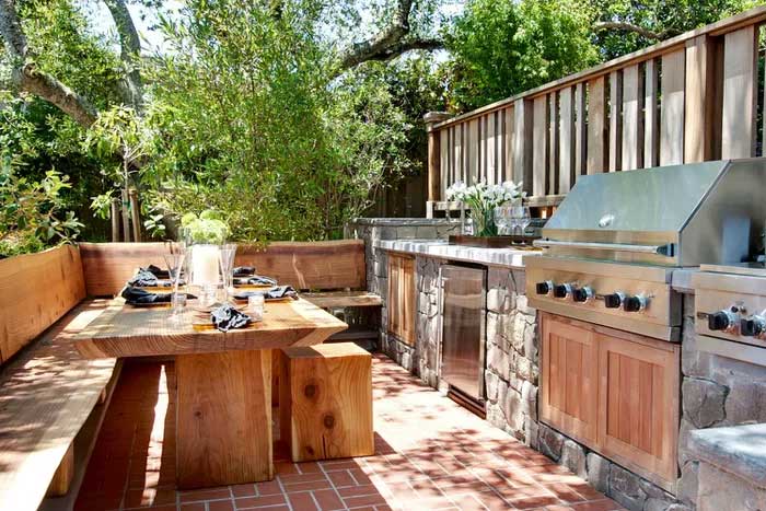 elegant wooden outdoor kitchen with rock countertop