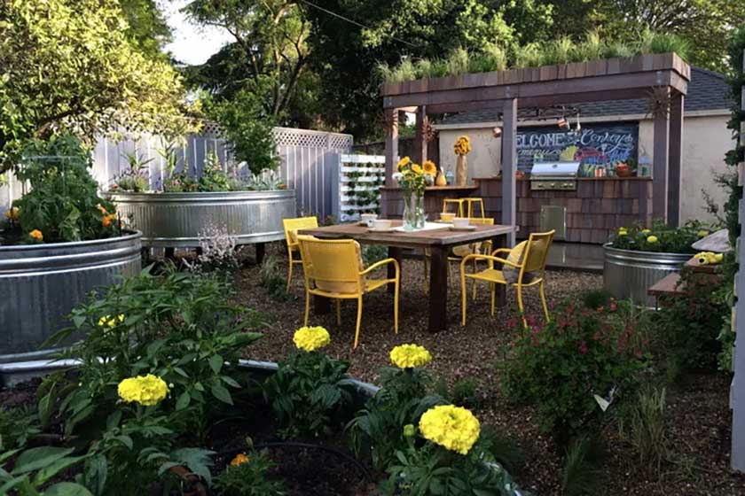 outdoor dining and kitchen with metal flower pots