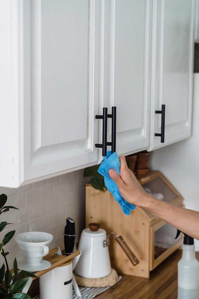 white floating kitchen cabinet with black handles